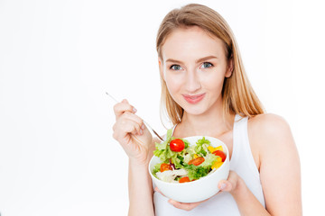 Pretty woman eating fresh salad