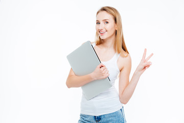 Woman holding laptop computer and showing two fingers sign