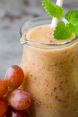 Grape smoothie, on the grey  background.
