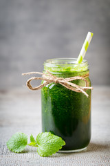 Spinach smoothie, on the grey  background.