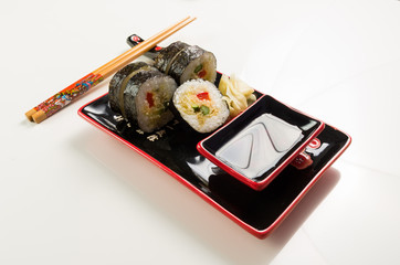 serving of sushi on a plate on a white background