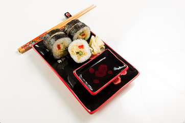 serving of sushi on a plate on a white background