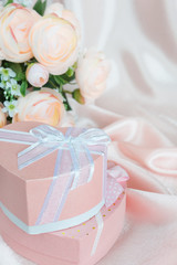 Festive composition with camellias and gift box
