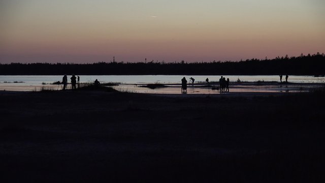Group of photographers shooting at sunset