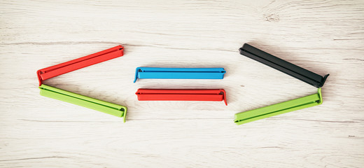 Smaller-than, greater-than and equal sign of colorful bag clips