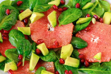 Healthy salad with spinach, avocado and citrus fruits