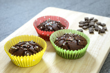 Group of muffins on wood chopping board