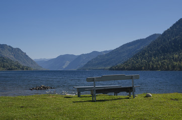 Naklejka na ściany i meble Bench by the lake in the mountains