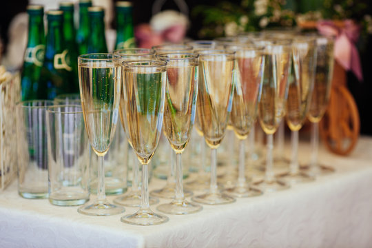 Dish with champagne and wine glasses. On outdoor wedding recepti