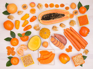 Orange fruit and vegetables containing plenty of beta carotene - obrazy, fototapety, plakaty