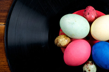 Colorful eggs and quail eggs on vinyl