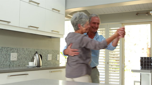 Senior couple smiling and dancing