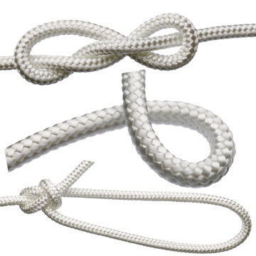 A set of knots on a white rope, isolated on a white background.