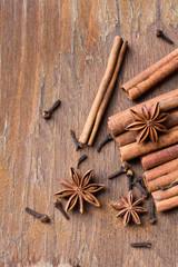 cinnamon sticks, star anise and cloves on wooden background