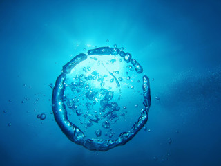 ring and bubbles from air rises upwards in water