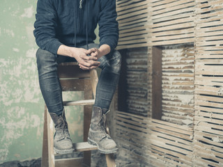 Person resting on stepladder