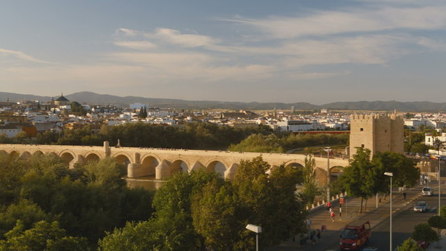 Sunset at Cordoba, Spain, with a bridge in the middleground and the cathedral at background