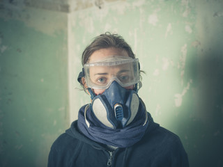 Young woman with dust mask and goggles