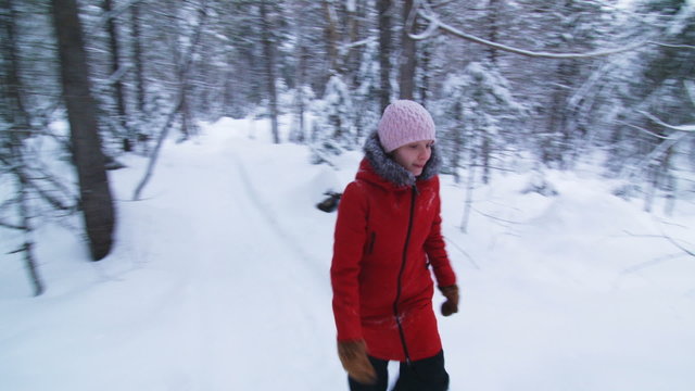Steadicam Video of Young Woman Walking in Forest during Winter