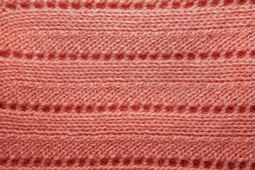 Pink wool sweater texture close up.