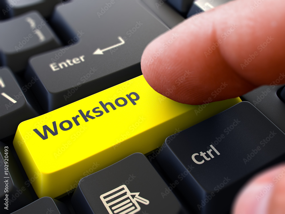 Aufkleber finger presses yellow button workshop on black keyboard background. closeup view. selective focus. 3