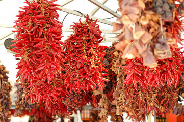 dried red chillies hanging on a market place