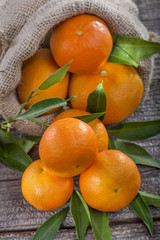 Mandarins in linen bag on a wooden base