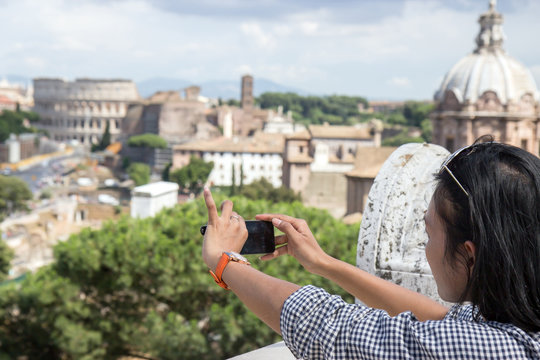 woman photographing the Coliseum in Rome