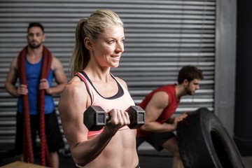 Portrait of fit woman lifting dumbbells
