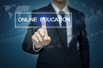 Businessman hand touching ONLINE EDUCATION button on virtual scr
