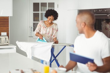Fototapeta premium Young man using tablet in kitchen
