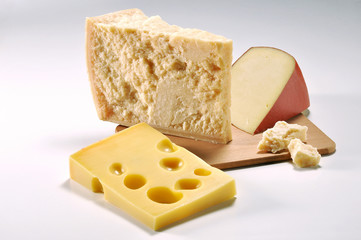 Three slices of Cheese on cutting board