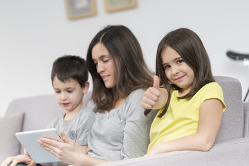 Fototapeta na wymiar Smiling mother and children using tablet