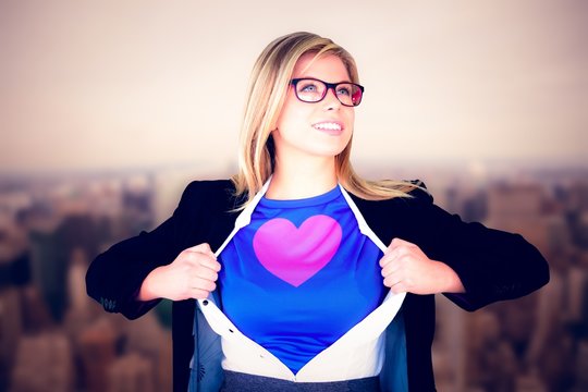Composite image of businesswoman opening her shirt superhero 