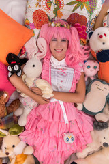 young girl in a bedroom in a pink cute dress