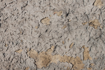 The old crumbling plaster for concrete. Part of the old wall building