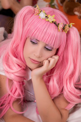 young girl in a bedroom with a pink wig