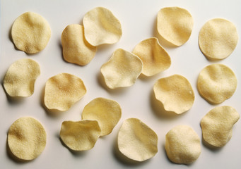 Potato chips on white plane