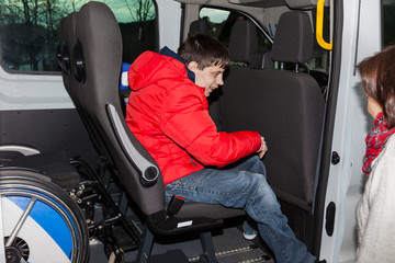 Handicapped boy is picked up by school bus © zaschnaus