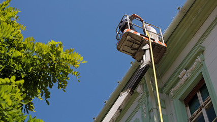 Construction Workers on Hydraulic Platform