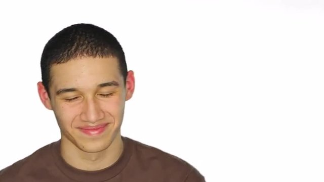 Young man makes silly faces, on a white studio background