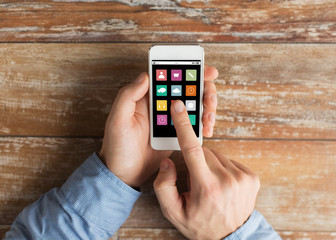 close up of male hands with smartphone on table