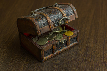Treasure chest with old russian coin and have a wood floor in the background
