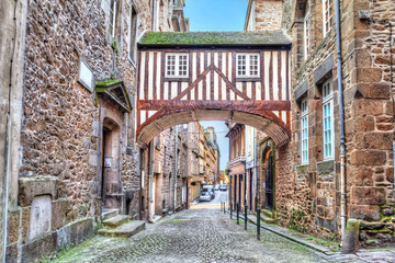 Wooden brigde between two buildigs on narrow street in Saint-Malo, Brittany, France - obrazy, fototapety, plakaty