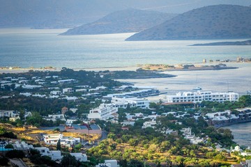 Obraz premium The Top View from Mountains on the Sea and the City in Crete, Greece, Beautiful Landscape in the Evening