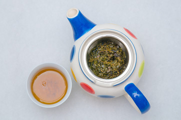 Top view of Glass teapot with Chinese tea on white blackground.