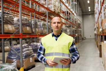 manual worker with tablet pc at warehouse