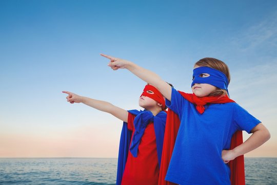 Composite image of masked kids pretending to be superheroes