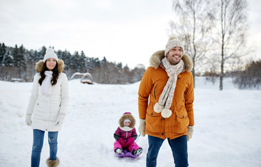 Fototapeta na wymiar happy family with sled walking in winter outdoors