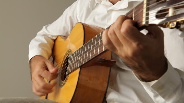 Man playing spanish guitar while singing